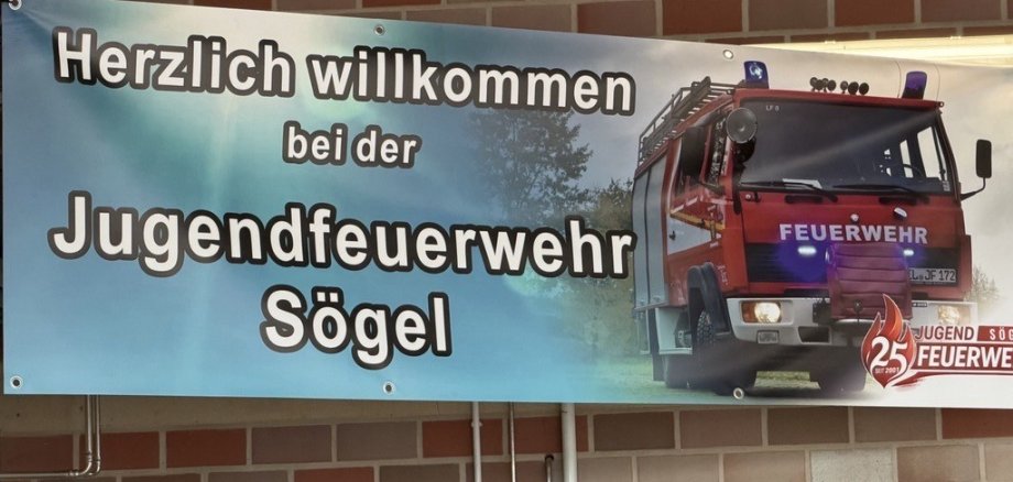 Auf dem Bild ist ein Banner mit der Aufschrift "Herzlich willkommen bei der Jugendfeuerwehr Sögel" zu sehen