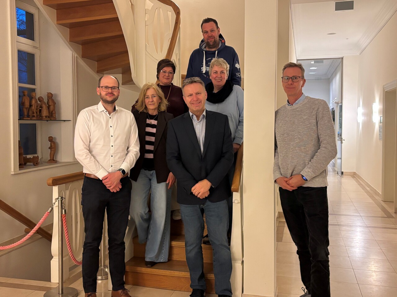 Ein Bild mit mehreren Personen auf einer Treppe