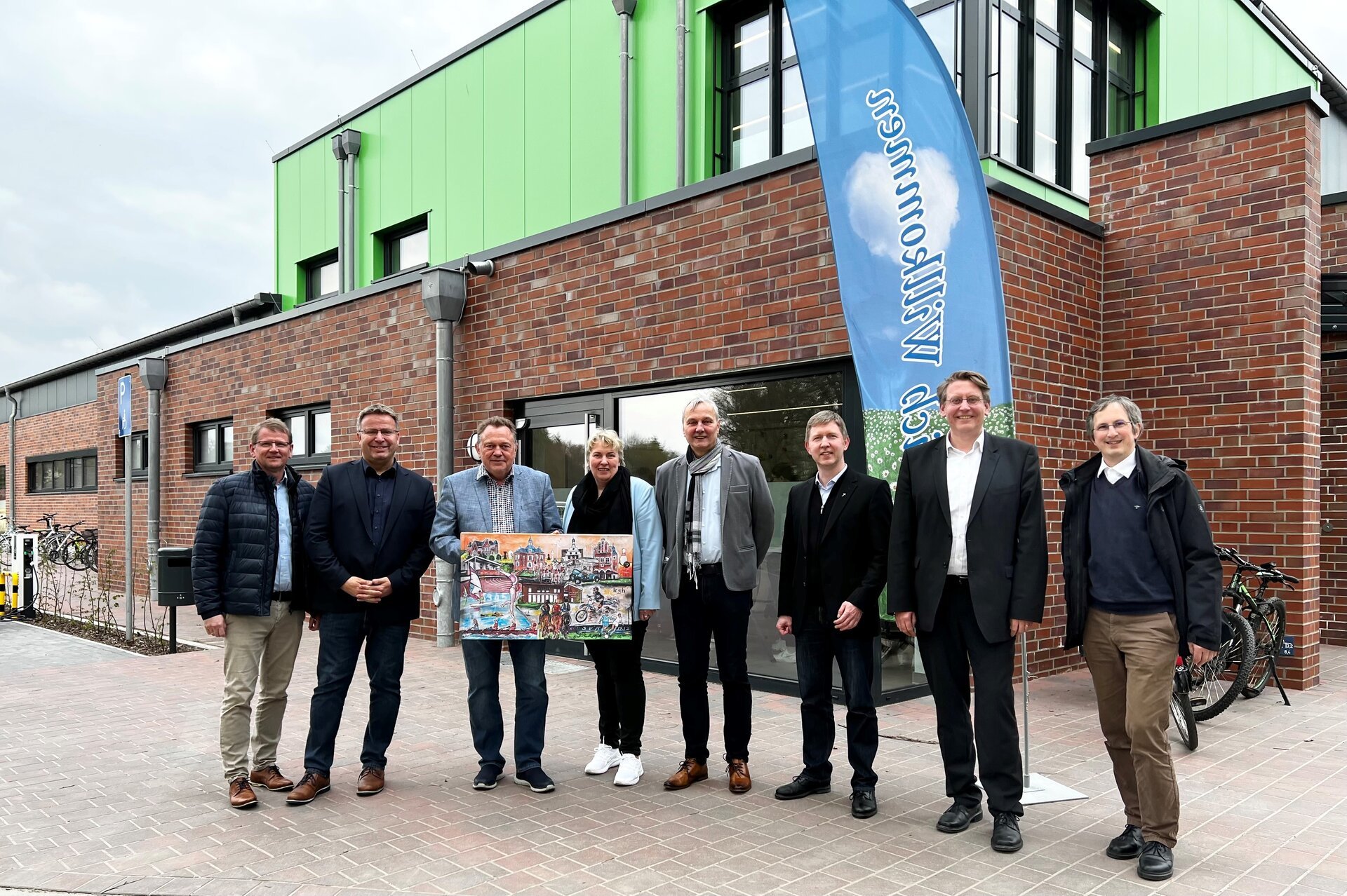 Ein Bild mit mehreren Menschen vor einer Turnhalle