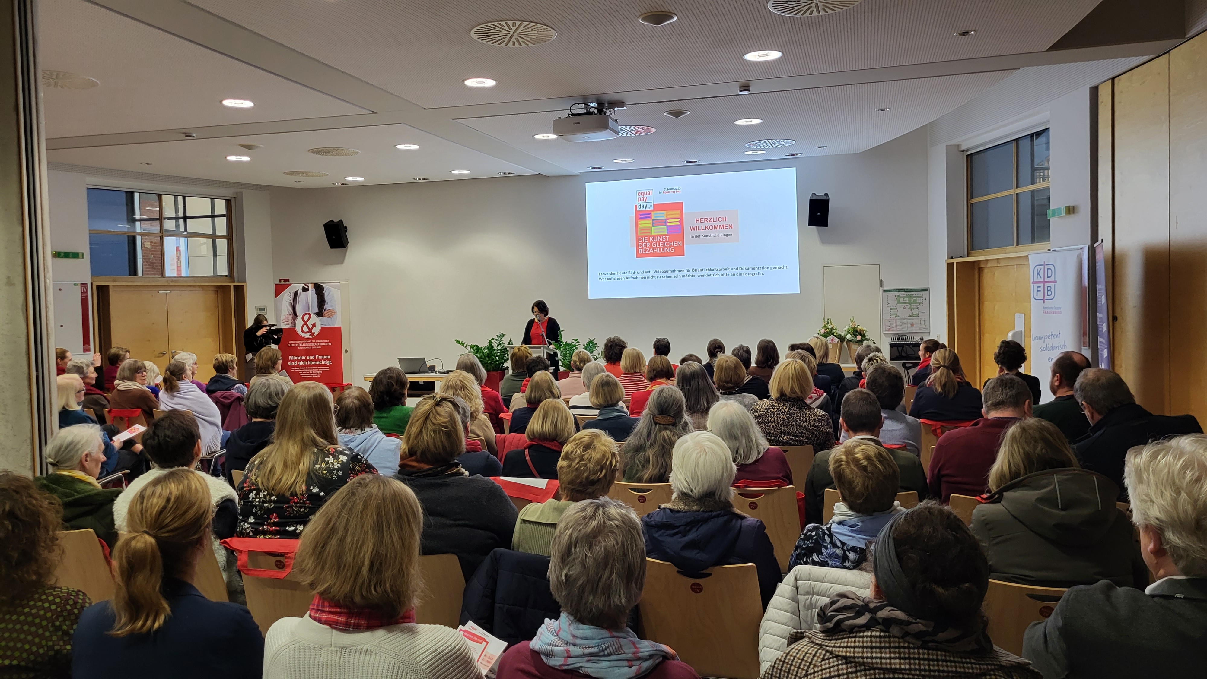 Ein Bild mit vielen Menschen im Saal