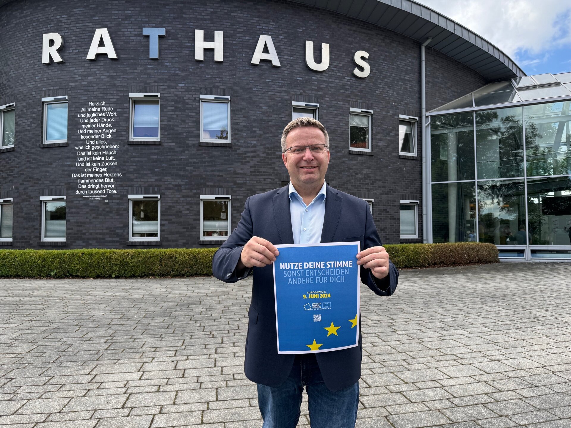 Ein Bild mit einer Person vor einem Gebäude