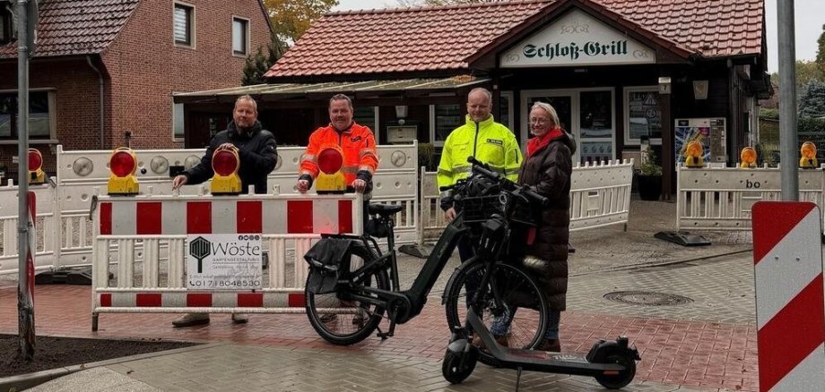 in Bild mit einem Bauschild und mehreren Personen